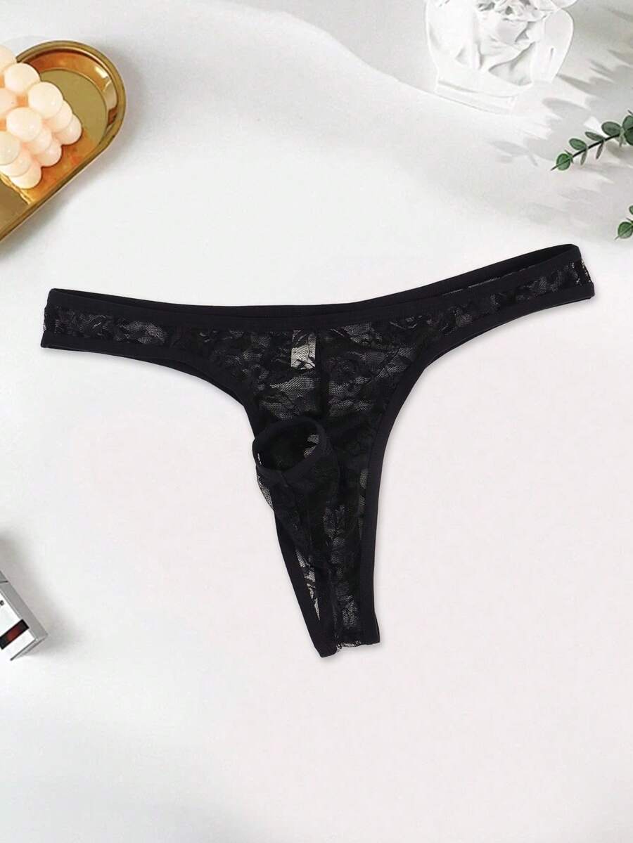 Men's black semi-sheer floral lace thong underwear featuring cut out design and low rise waistband.