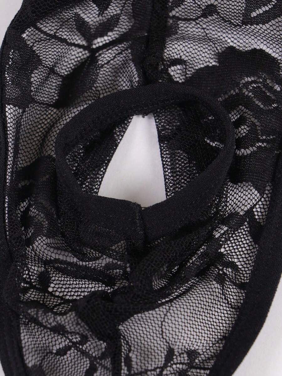 Men's black semi-sheer floral lace thong underwear featuring cut out design and low rise waistband.