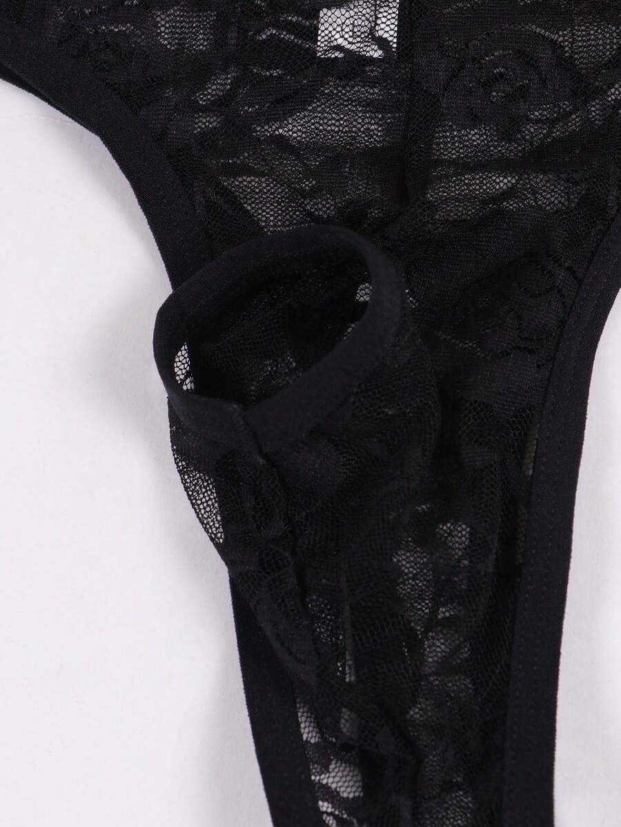 Men's black semi-sheer floral lace thong underwear featuring cut out design and low rise waistband.