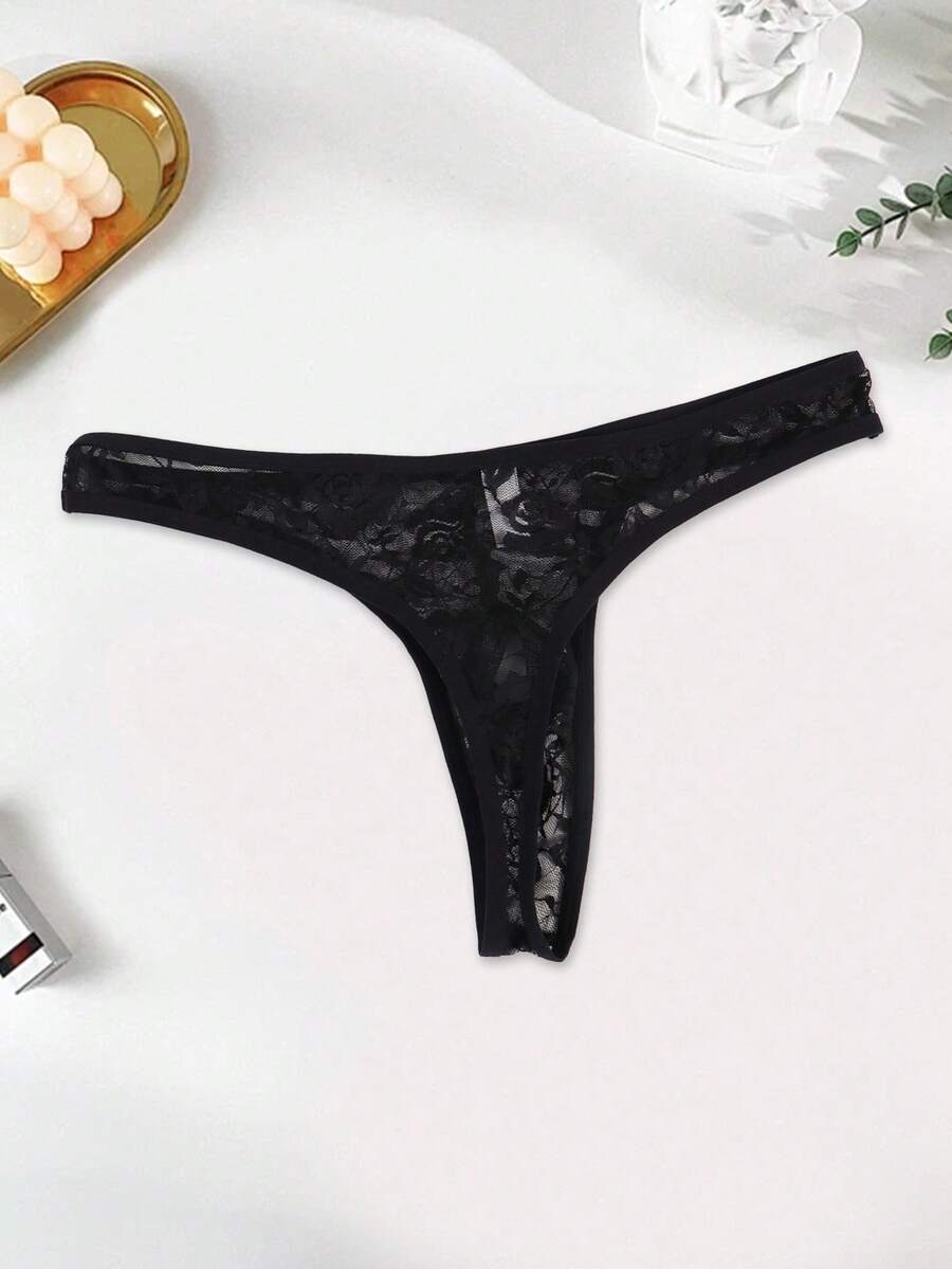 Men's black semi-sheer floral lace thong underwear featuring cut out design and low rise waistband.