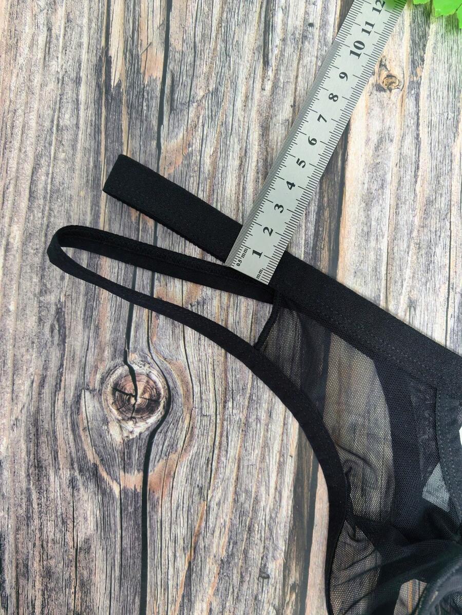 Men's black mesh G-string thong underwear featuring a low-waist cut-out front design.