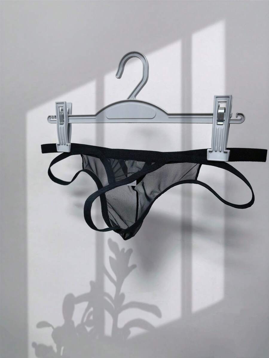 Men's black mesh G-string thong underwear featuring a low-waist cut-out front design.