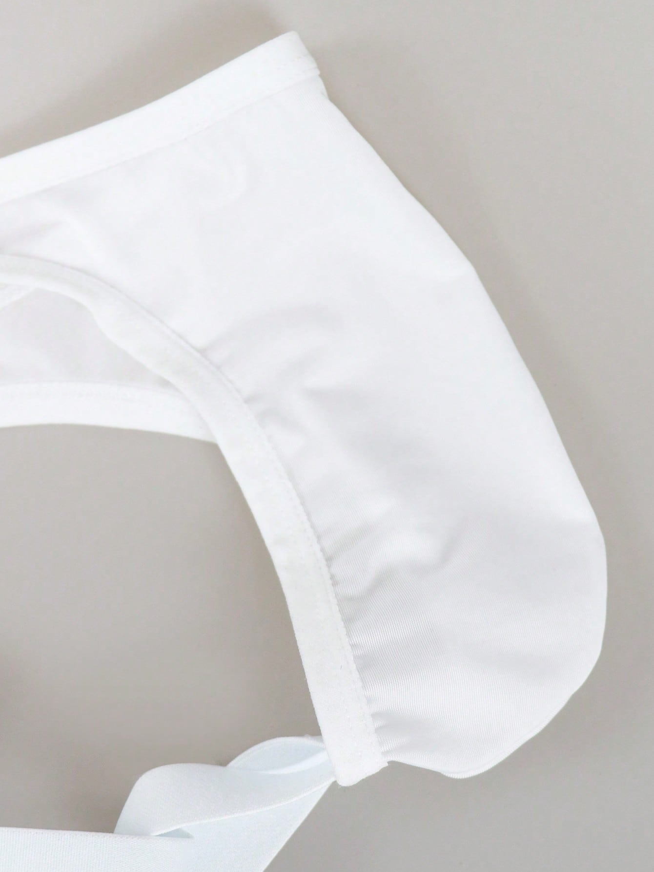 Men's solid color jockstrap underwear in knitted fabric with a breathable hollow design, low rise fit, plain pattern, and medium stretch for daily wear.