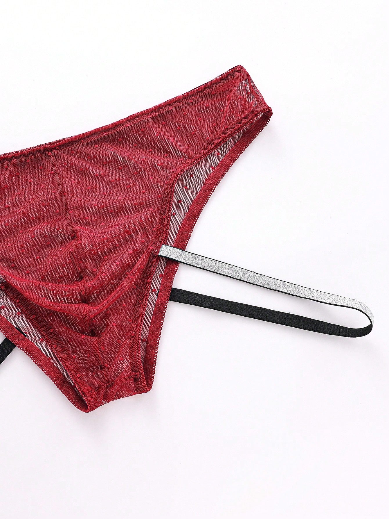 Men's low rise briefs in burgundy knitted fabric with lace trim, geometric pattern, medium stretch, and a semi-sheer finish.