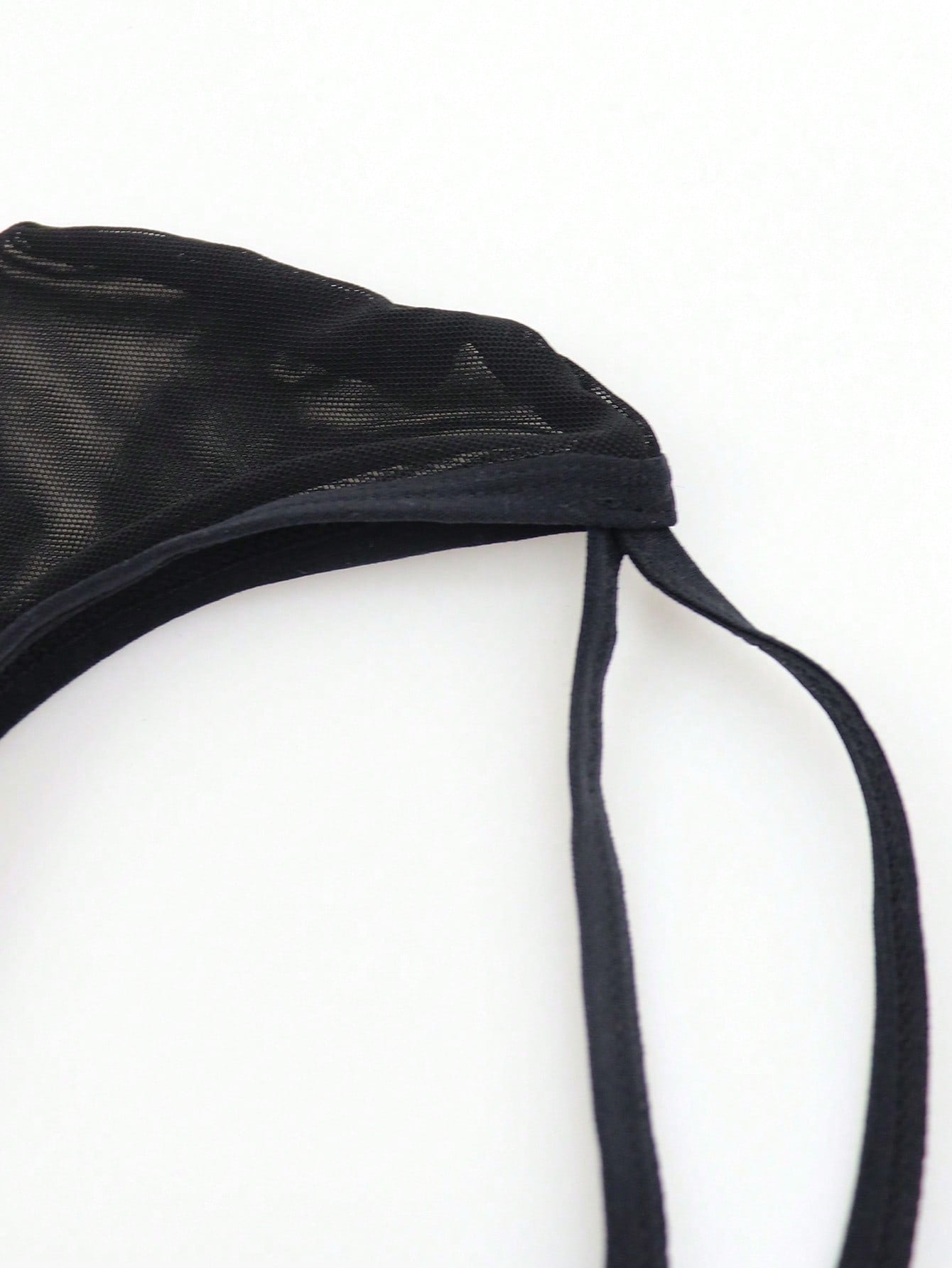 Black men's criss-cross mesh thong underwear with low rise V-string design and medium stretch fabric.