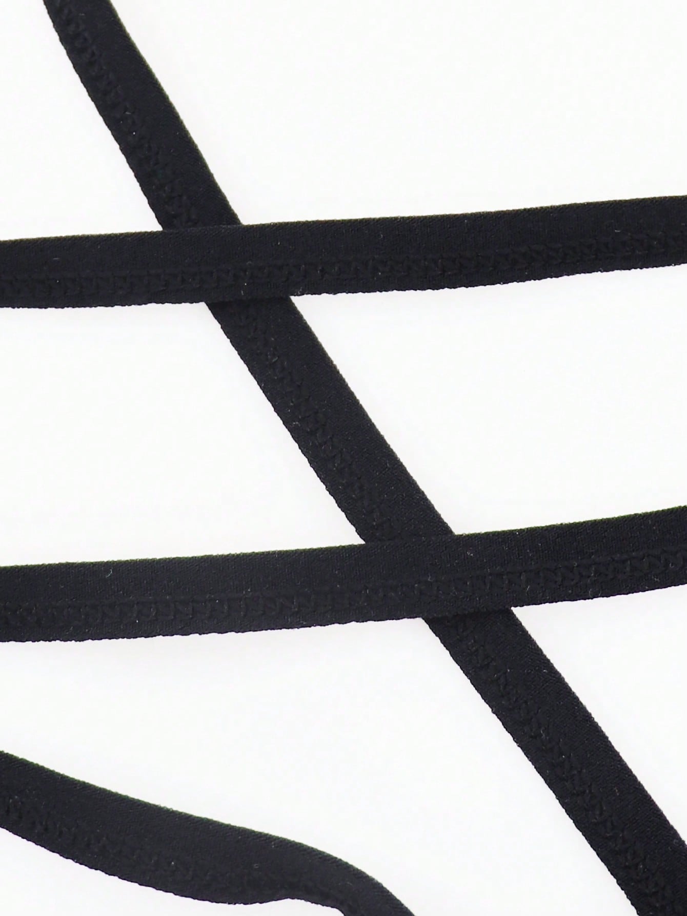Black men's criss-cross mesh thong underwear with low rise V-string design and medium stretch fabric.