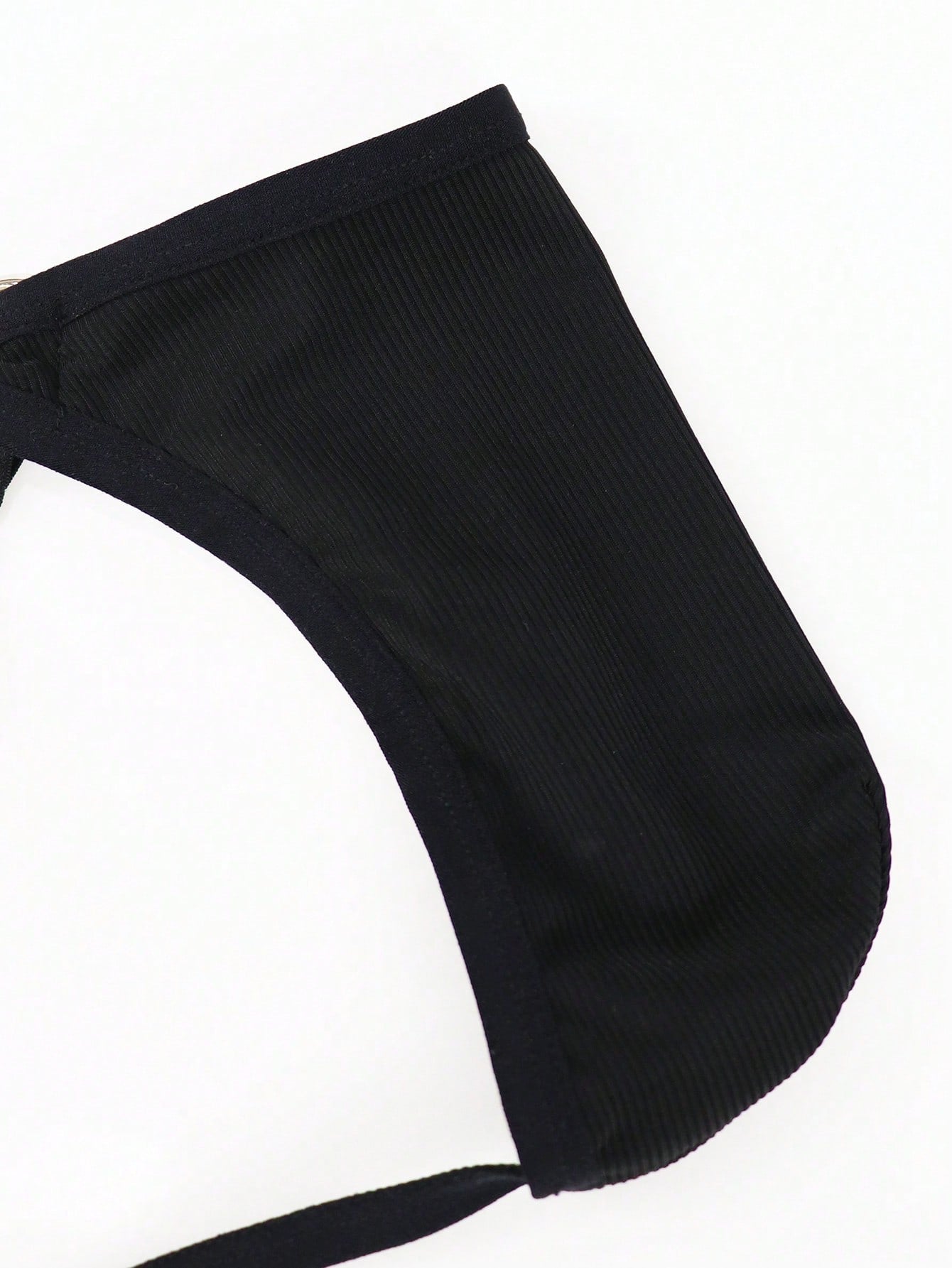 Men's black low rise thong briefs with cut out detail, plain pattern, and medium stretch knitted fabric