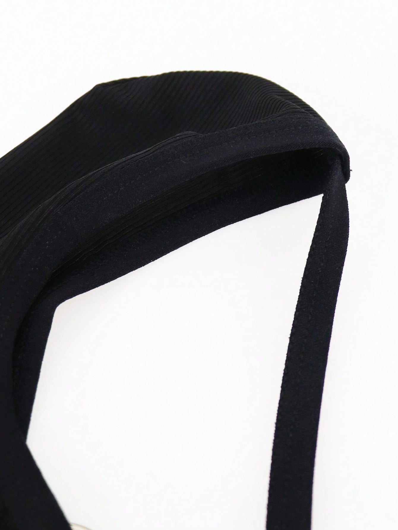 Men's black low rise thong briefs with cut out detail, plain pattern, and medium stretch knitted fabric