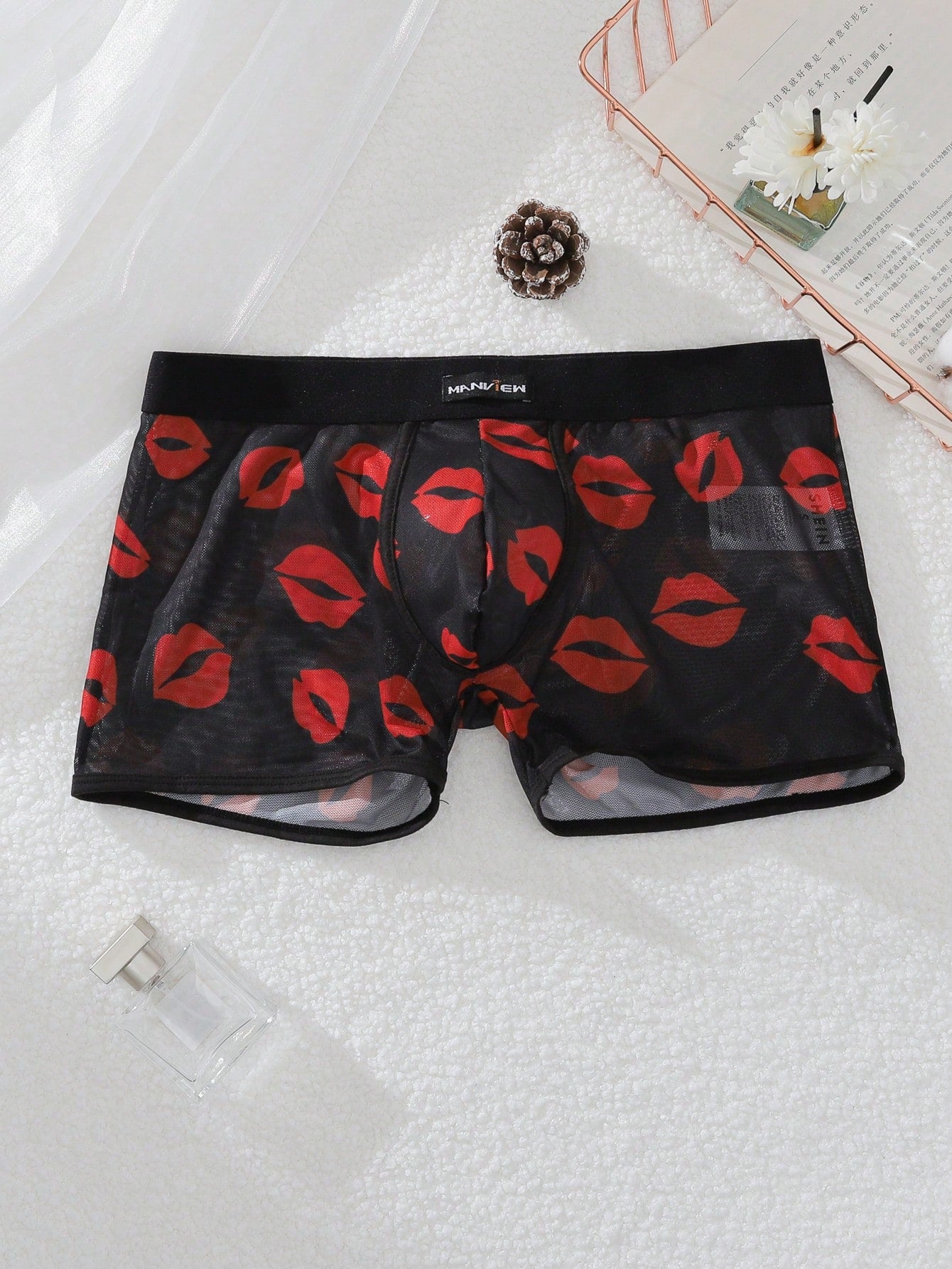 Red sheer men's mesh boxer shorts with tape detail, mid-rise waist, and slight stretch knitted fabric.