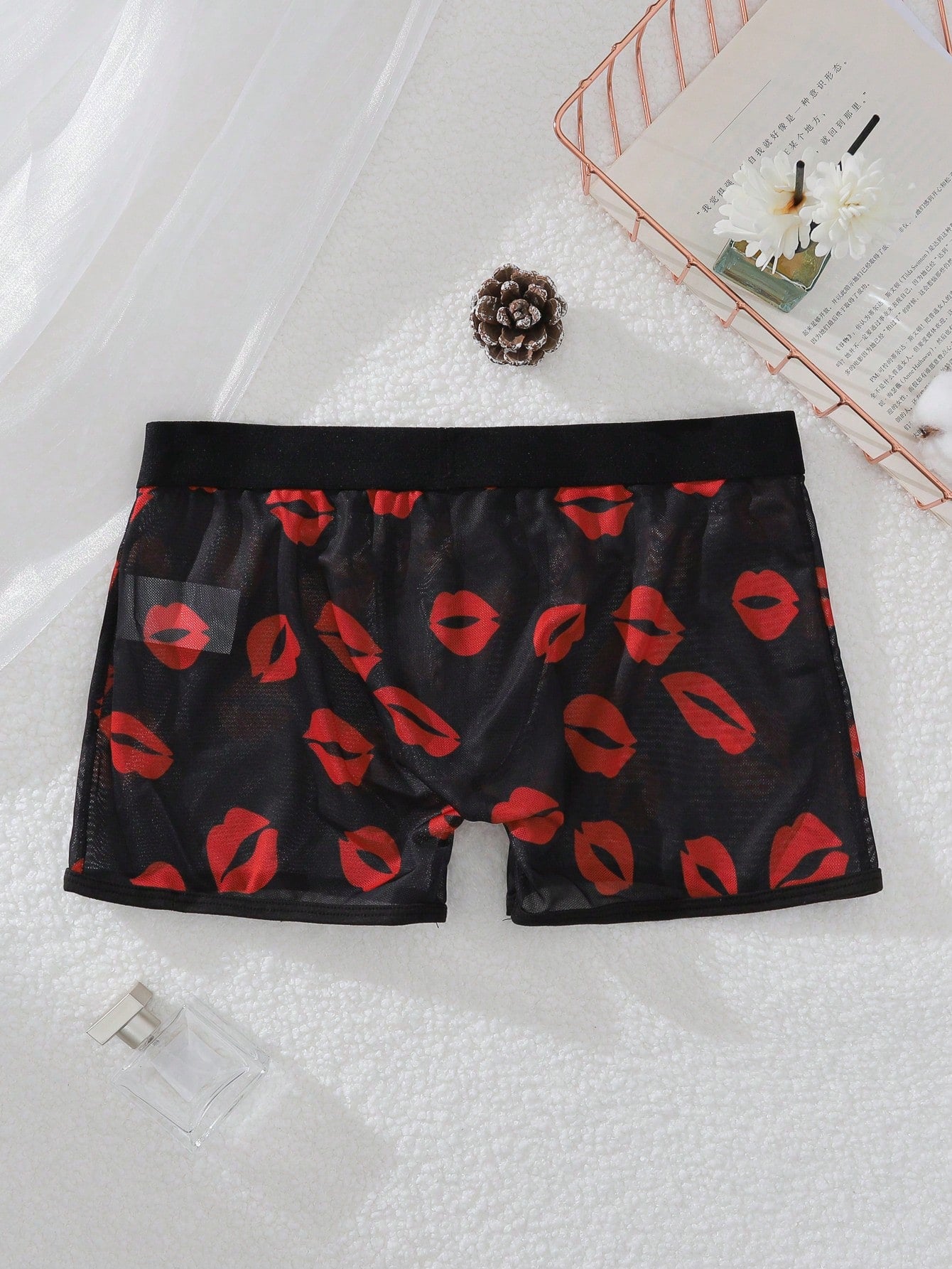 Red sheer men's mesh boxer shorts with tape detail, mid-rise waist, and slight stretch knitted fabric.