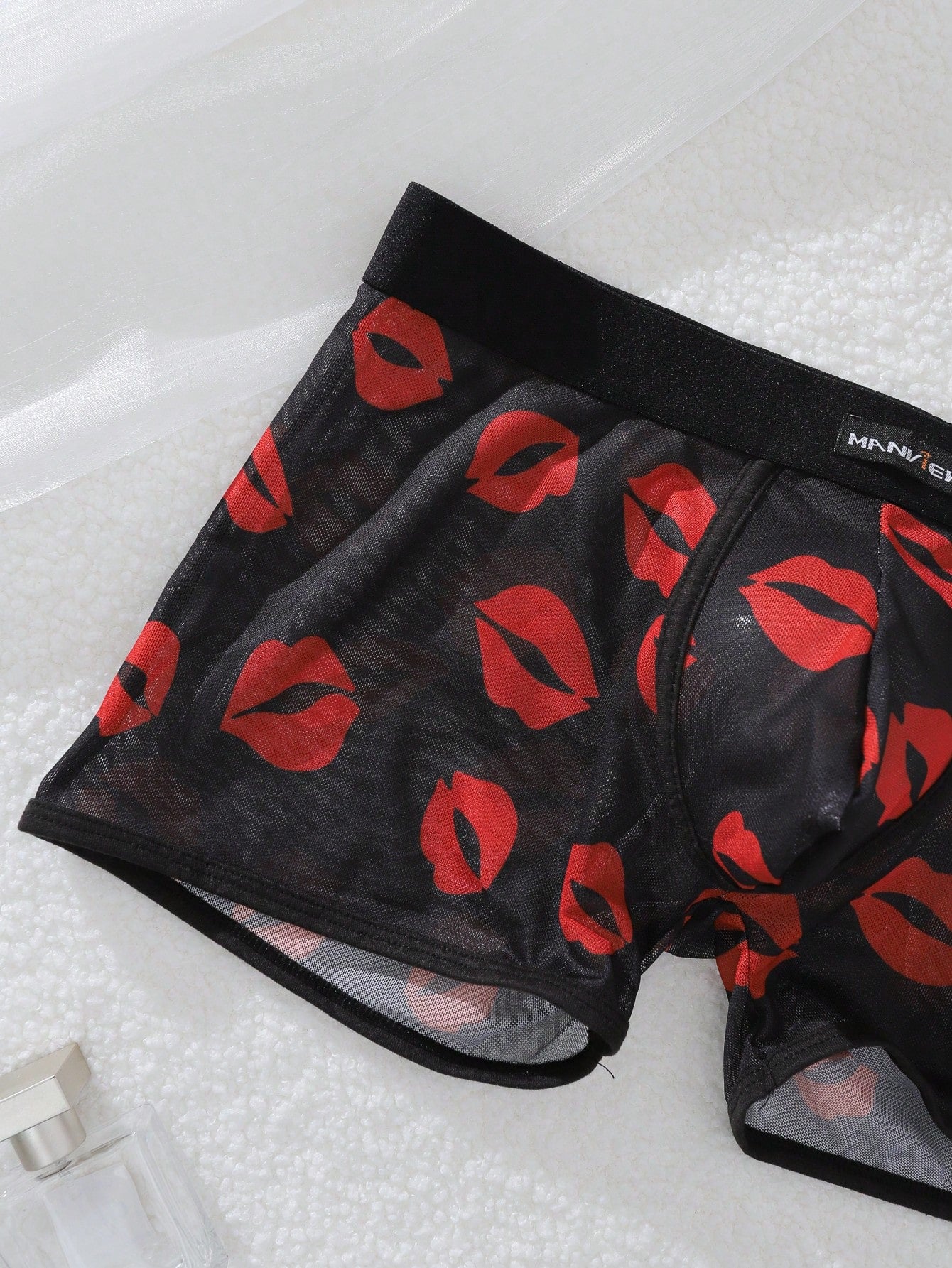 Red sheer men's mesh boxer shorts with tape detail, mid-rise waist, and slight stretch knitted fabric.