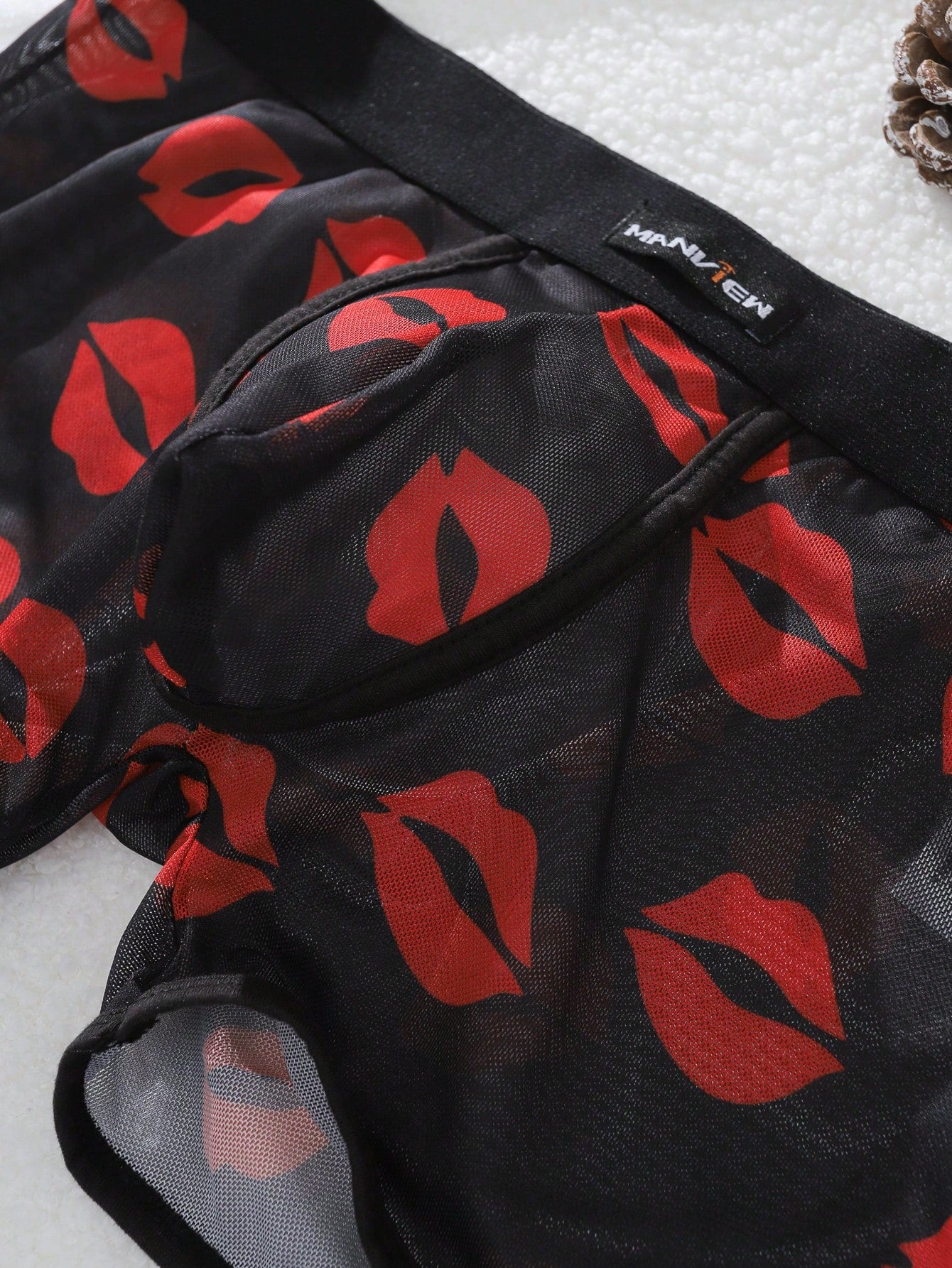 Red sheer men's mesh boxer shorts with tape detail, mid-rise waist, and slight stretch knitted fabric.