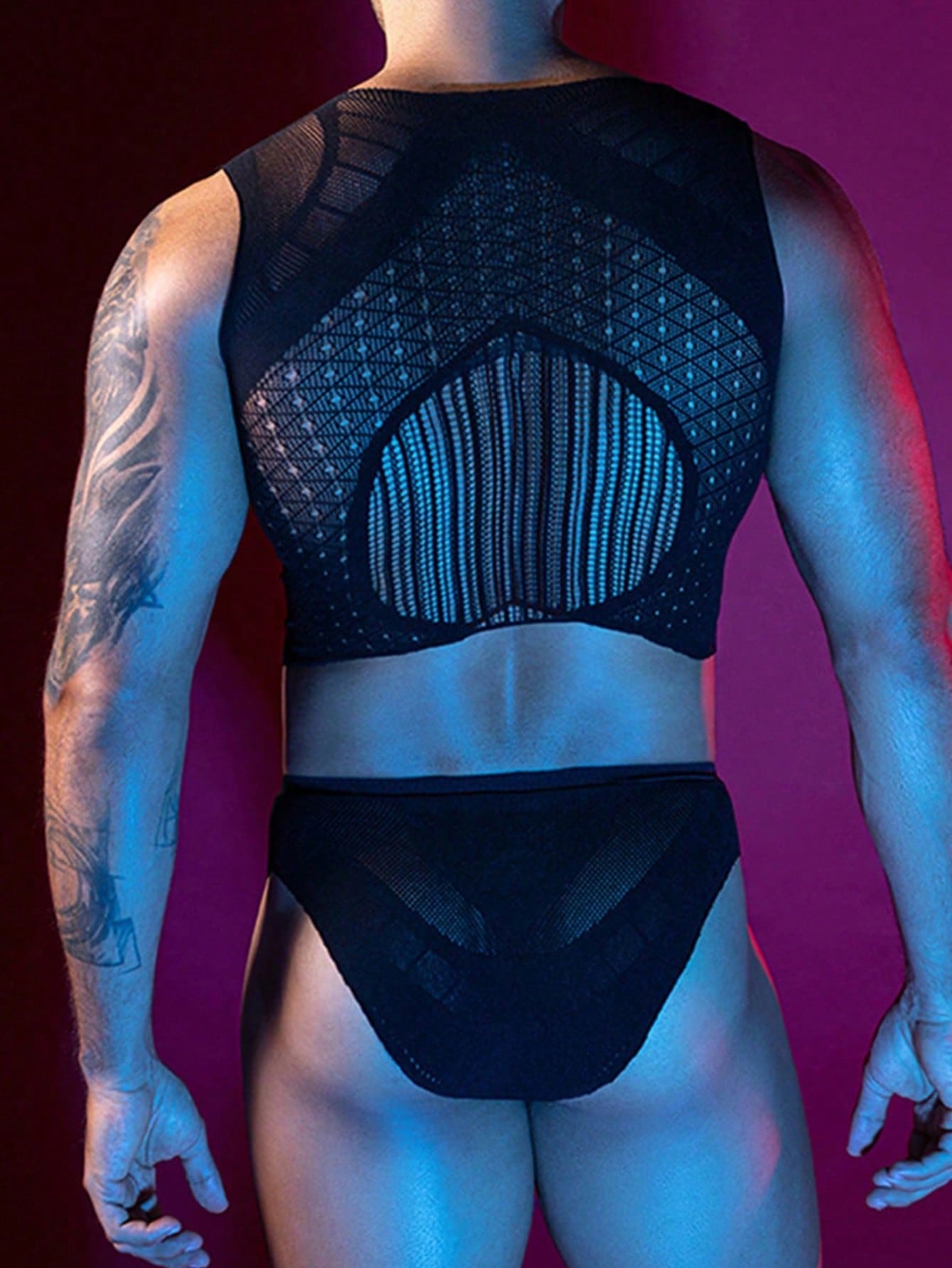 Men's black hollow-out mesh lingerie set with a cropped sleeveless tank top and matching briefs, featuring a round neck, backless design, sheer knitted fabric, and slim fit.