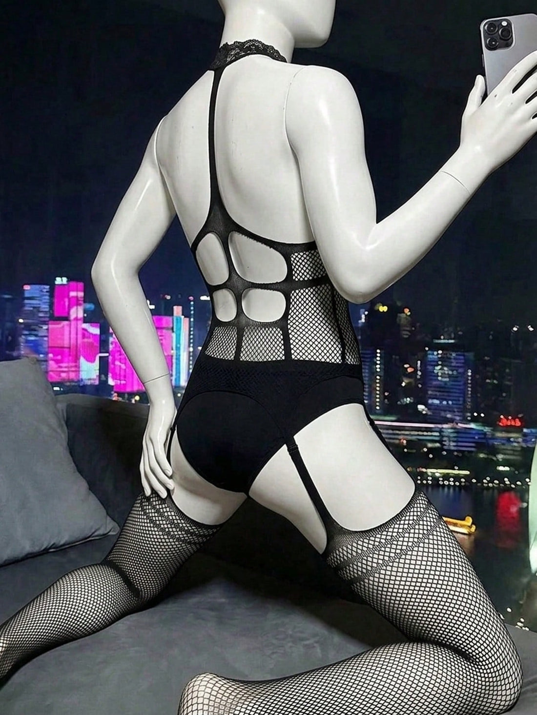 Men's black sheer bodysuit with cut out details, stand collar, sleeveless design, skinny fit, and high stretch polyamide fabric.