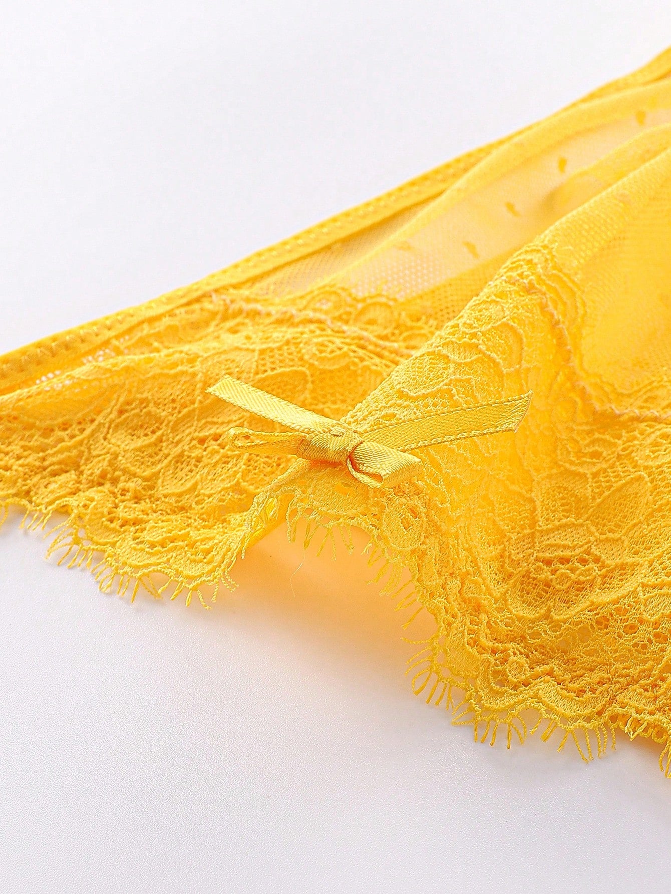 5-piece set of men's semi-sheer lace thong underwear in assorted colors with low rise fit, plain pattern, ring detail, and medium stretch knitted fabric.