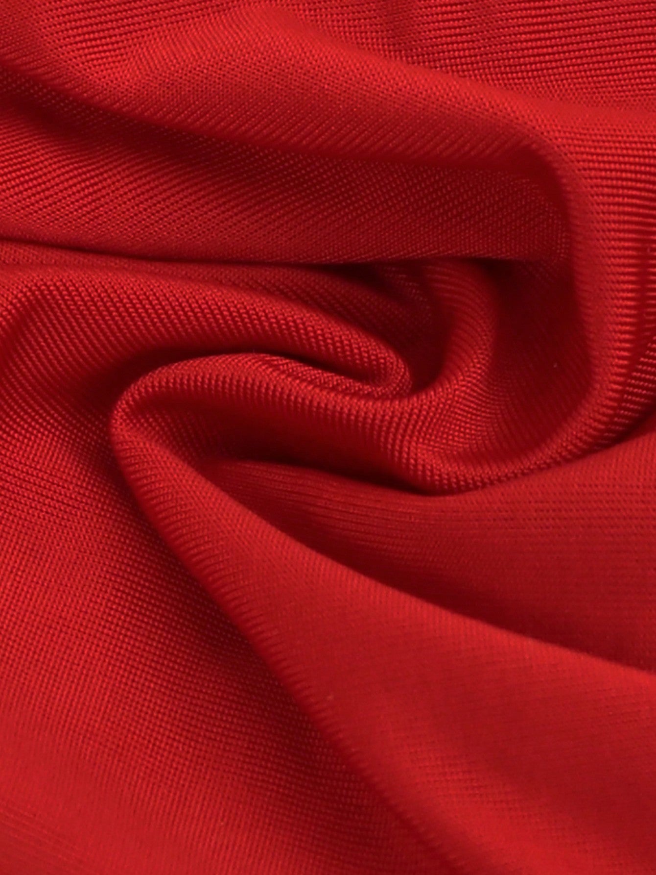 Men's red low-rise jockstrap underwear in knitted fabric with cut out detail, contrast binding, colorblock letter pattern, and medium stretch.