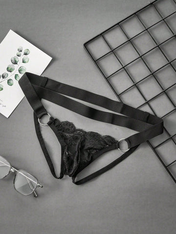 Black men's low-rise lace jockstrap underwear featuring hollow-out details and semi-sheer fabric.