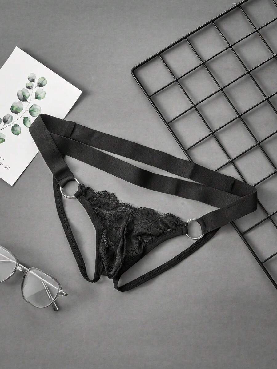 Black men's low-rise lace jockstrap underwear featuring hollow-out details and semi-sheer fabric.