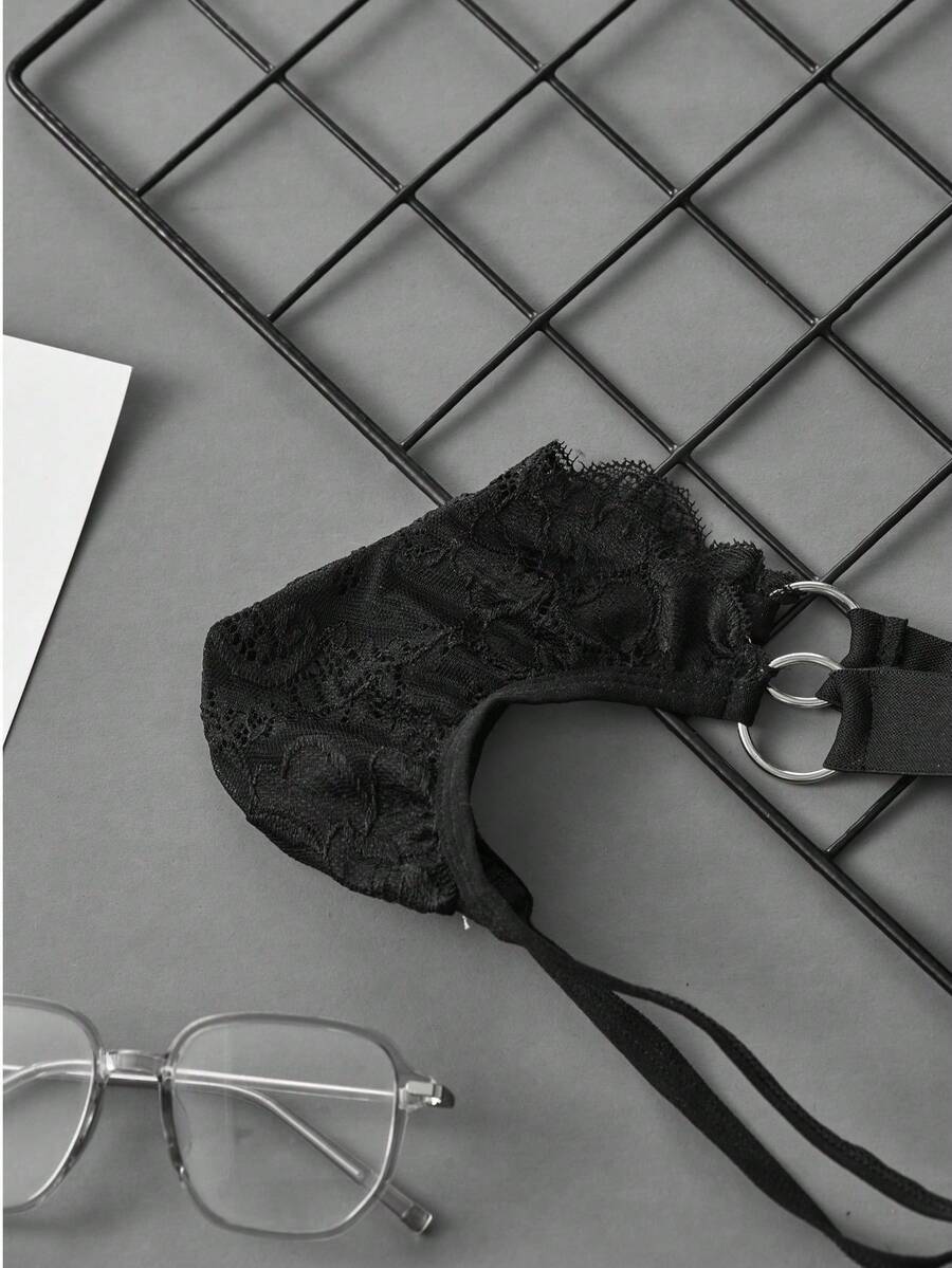 Black men's low-rise lace jockstrap underwear featuring hollow-out details and semi-sheer fabric.