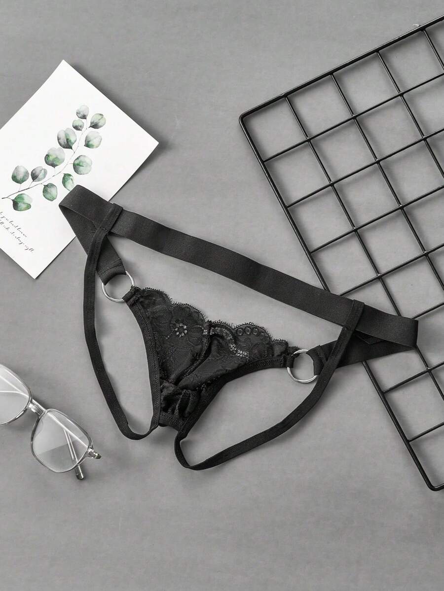 Black men's low-rise lace jockstrap underwear featuring hollow-out details and semi-sheer fabric.