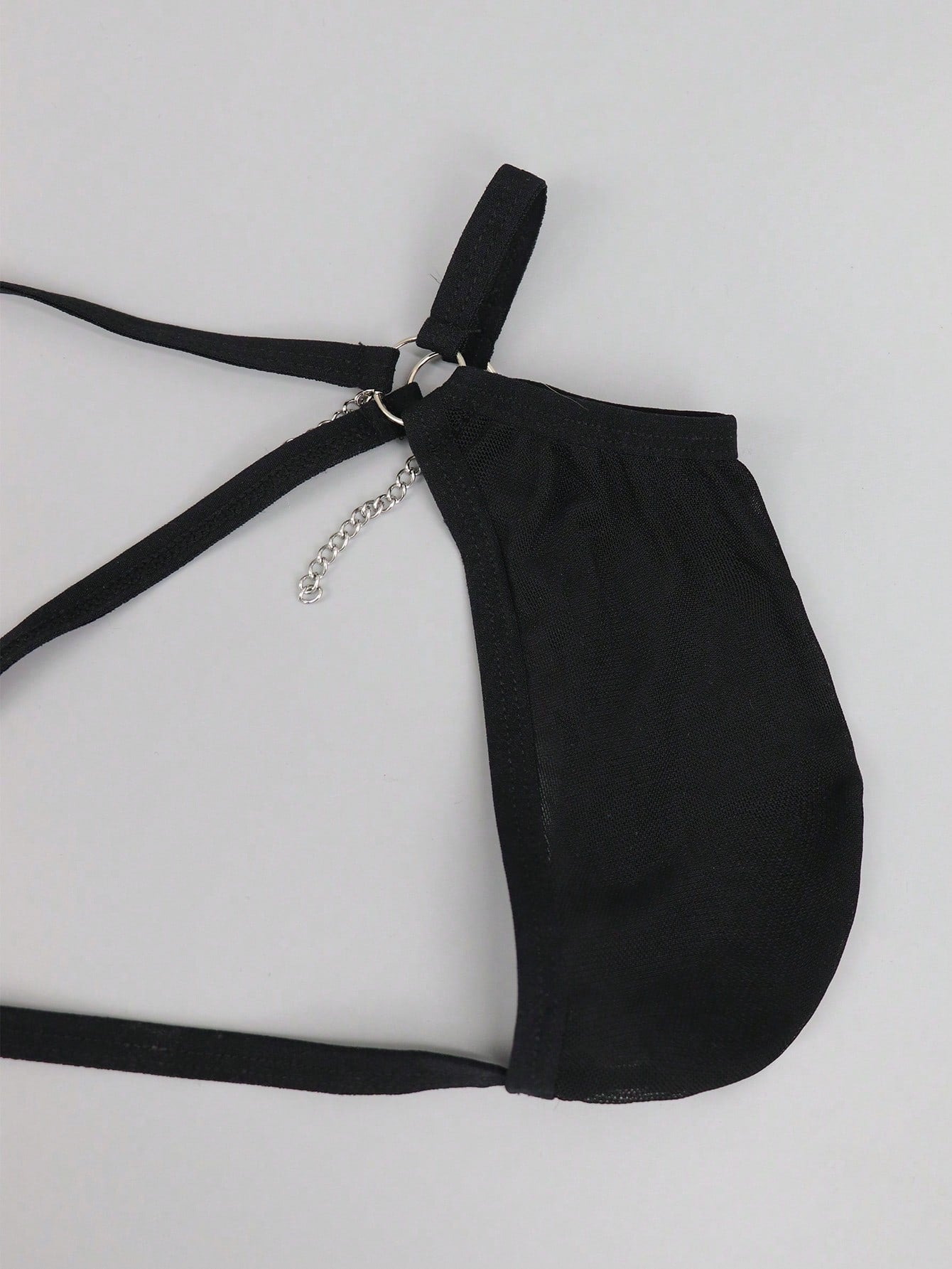 Men's black low rise mesh thong underwear with chain detail and colorblock design.
