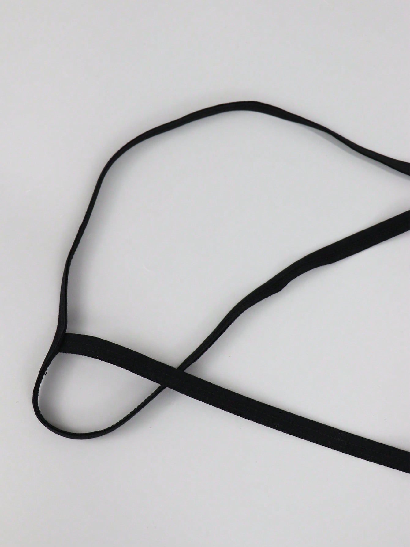 Men's black low rise mesh thong underwear with chain detail and colorblock design.