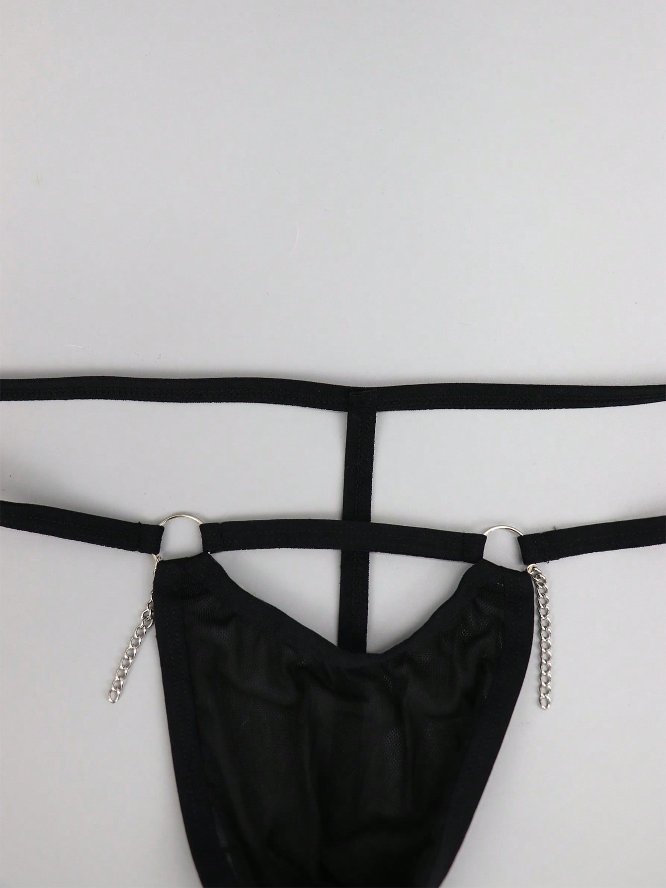 Men's black low rise mesh thong underwear with chain detail and colorblock design.