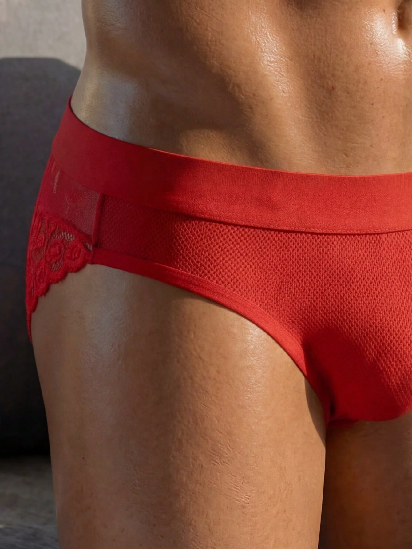 Men's low rise briefs with mesh and lace patchwork, plant pattern, and medium stretch fabric in red or white.