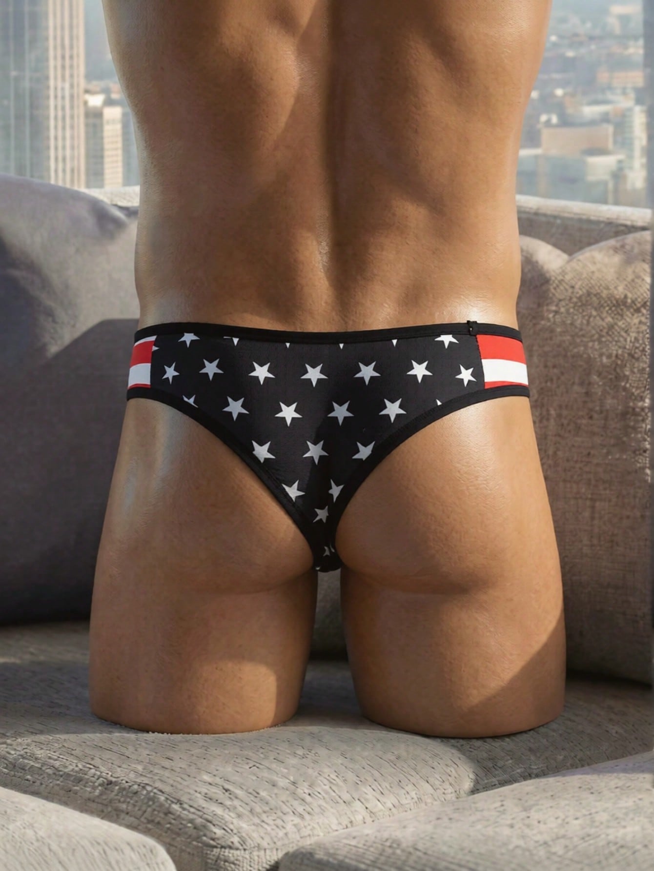 Men's black low rise thong underwear with geometric striped star print in high-stretch knitted fabric.