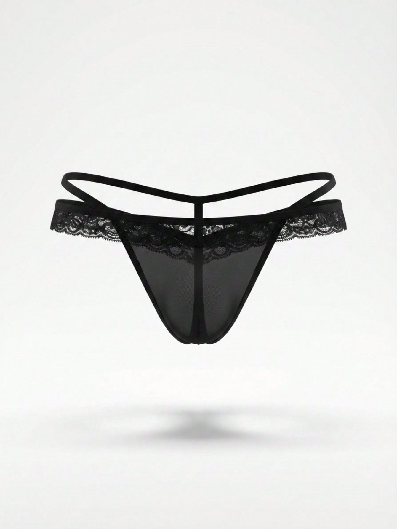 Men's low-rise thong underwear in black colorblock mesh fabric with medium stretch and lace detail.