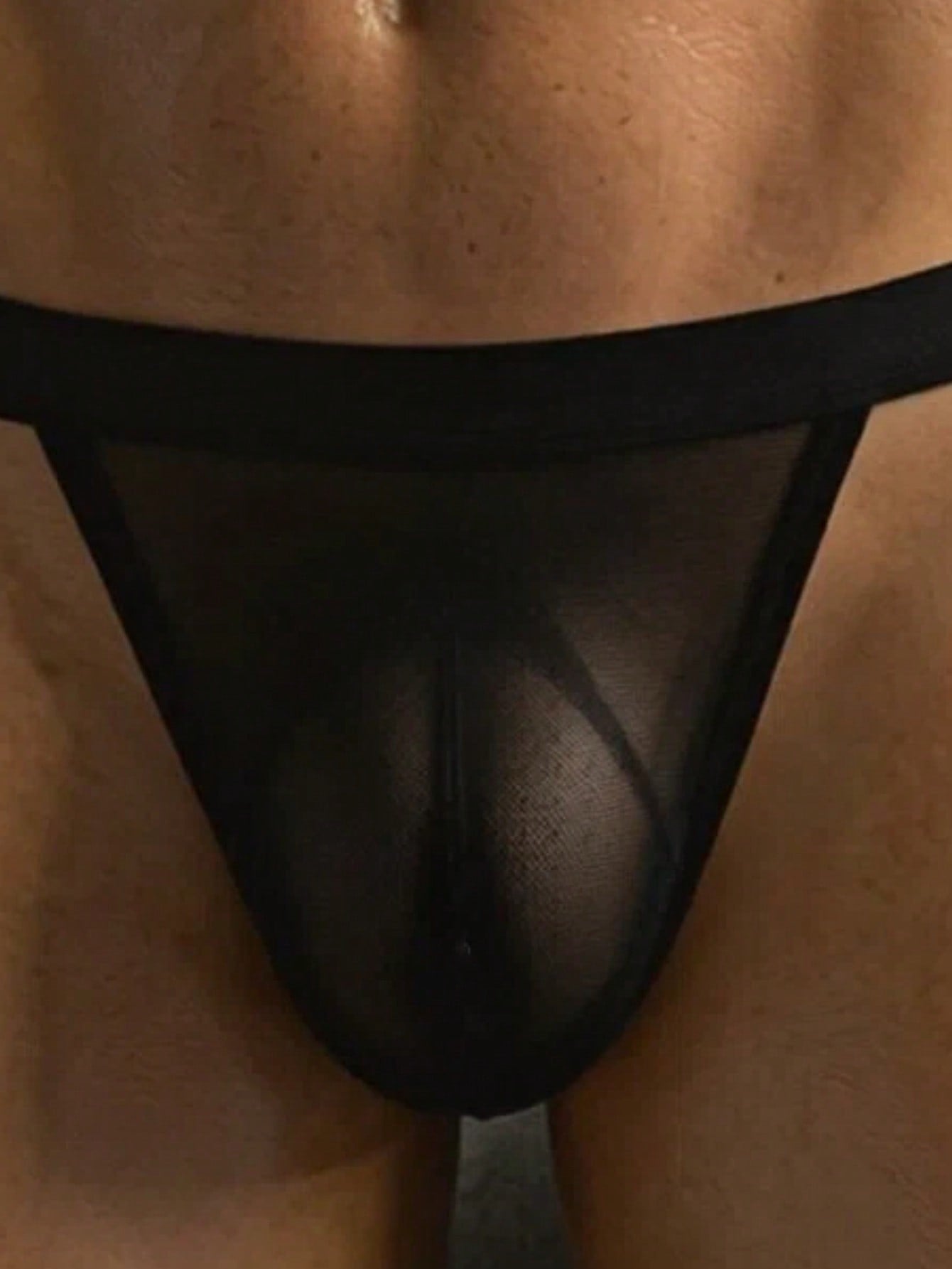 Black men's mesh thong underwear with a mid-rise fit, colorblock pattern, and medium-stretch fabric made from polyamide and elastane.