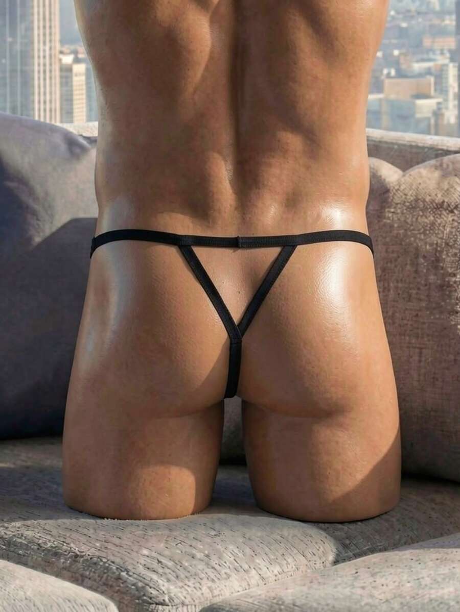 Black low rise men's thong with lace splice design and breathable mesh fabric.