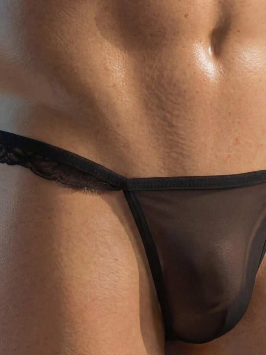 Black low rise men's thong with lace splice design and breathable mesh fabric.
