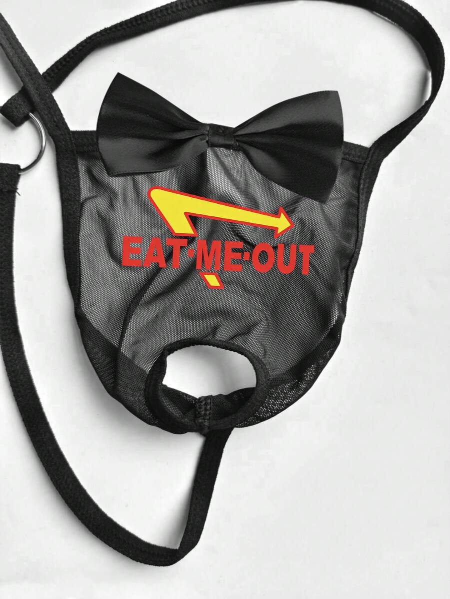 Black men's low rise open crotch G-string thong featuring letter print, bow decor, ring accent, and high stretch semi-sheer fabric.