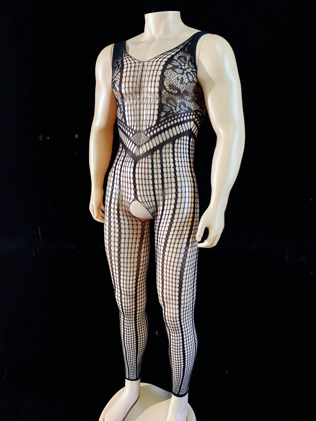 Black men's sheer bodysuit with cut-out design, plaid pattern, round neck, short length, and high-stretch polyamide elastane fabric.