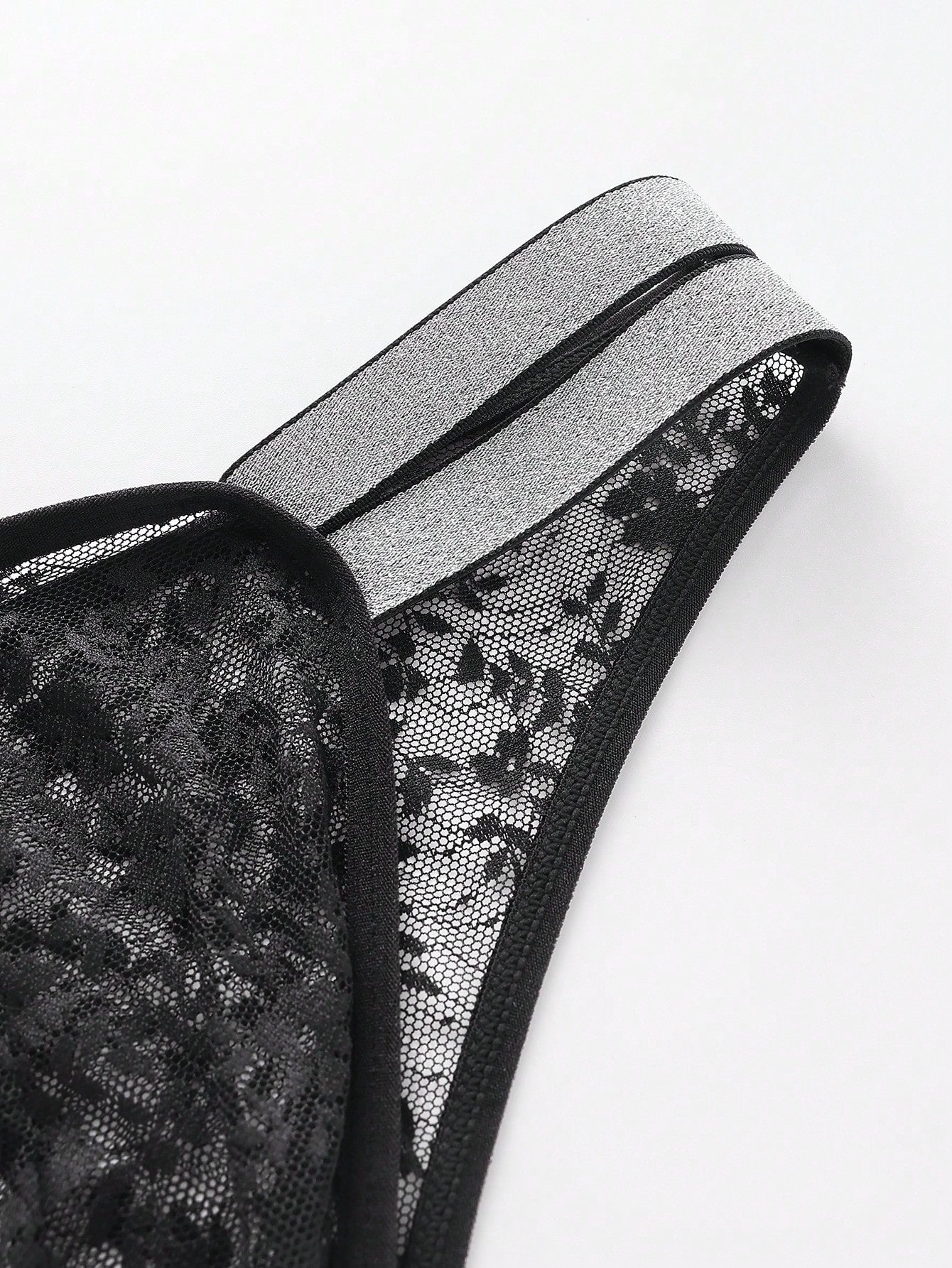 Men's black lace semi-sheer thong briefs with low rise fit and medium stretch fabric