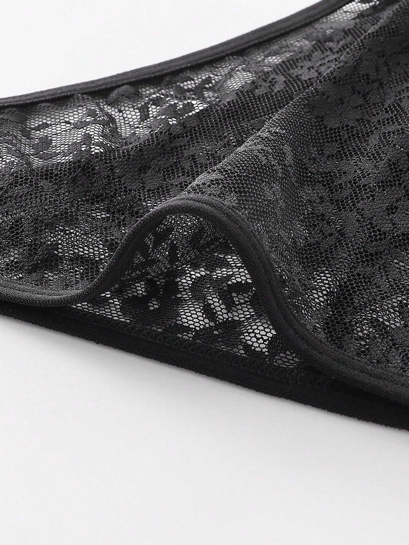 Men's black lace semi-sheer thong briefs with low rise fit and medium stretch fabric