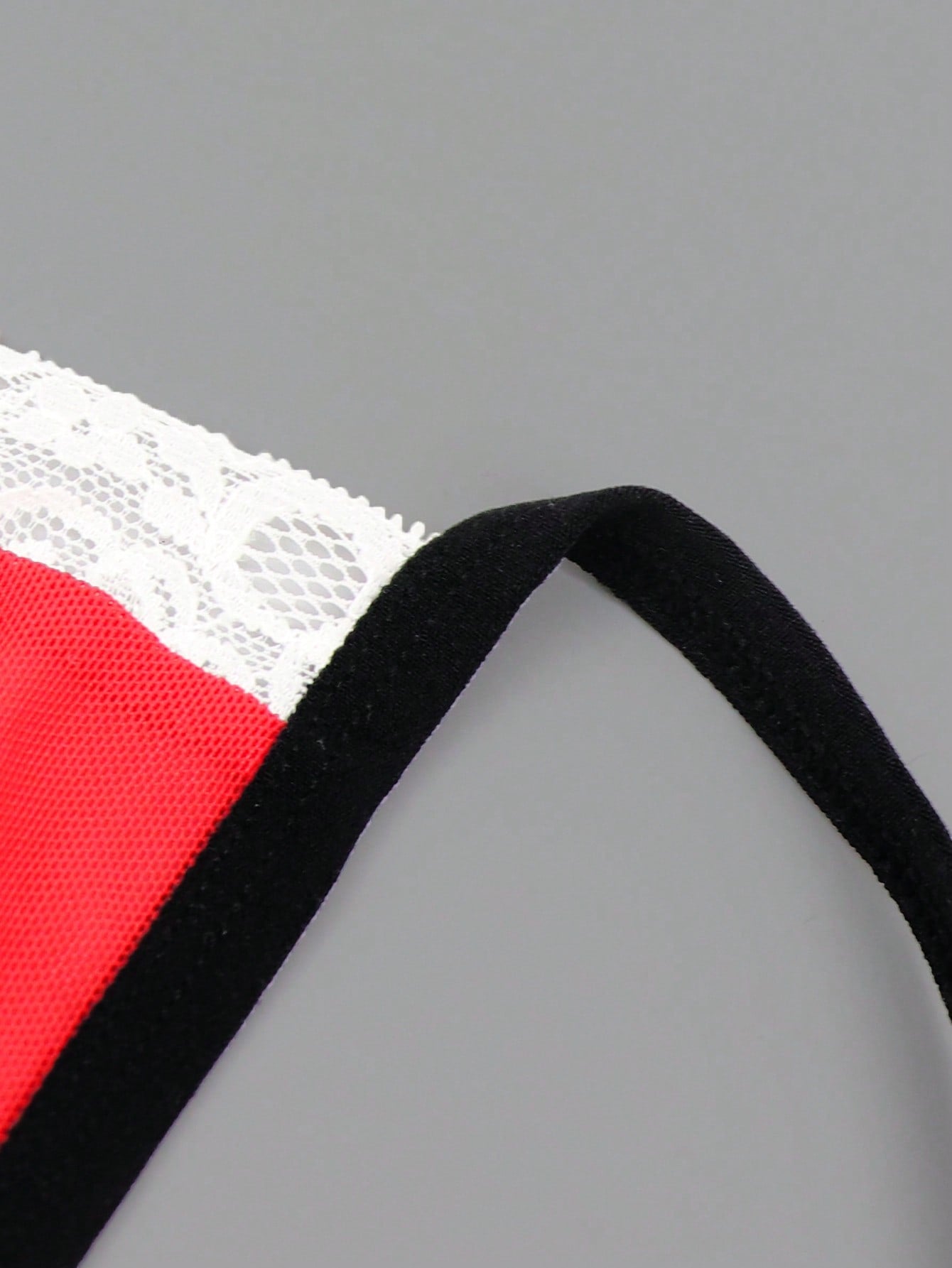 Men's low rise thong underwear in multicolor mesh fabric with contrast lace waistband, contrast binding, and colorblock design.