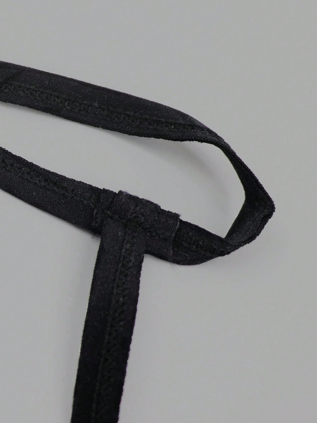 Men's low rise thong underwear in multicolor mesh fabric with contrast lace waistband, contrast binding, and colorblock design.