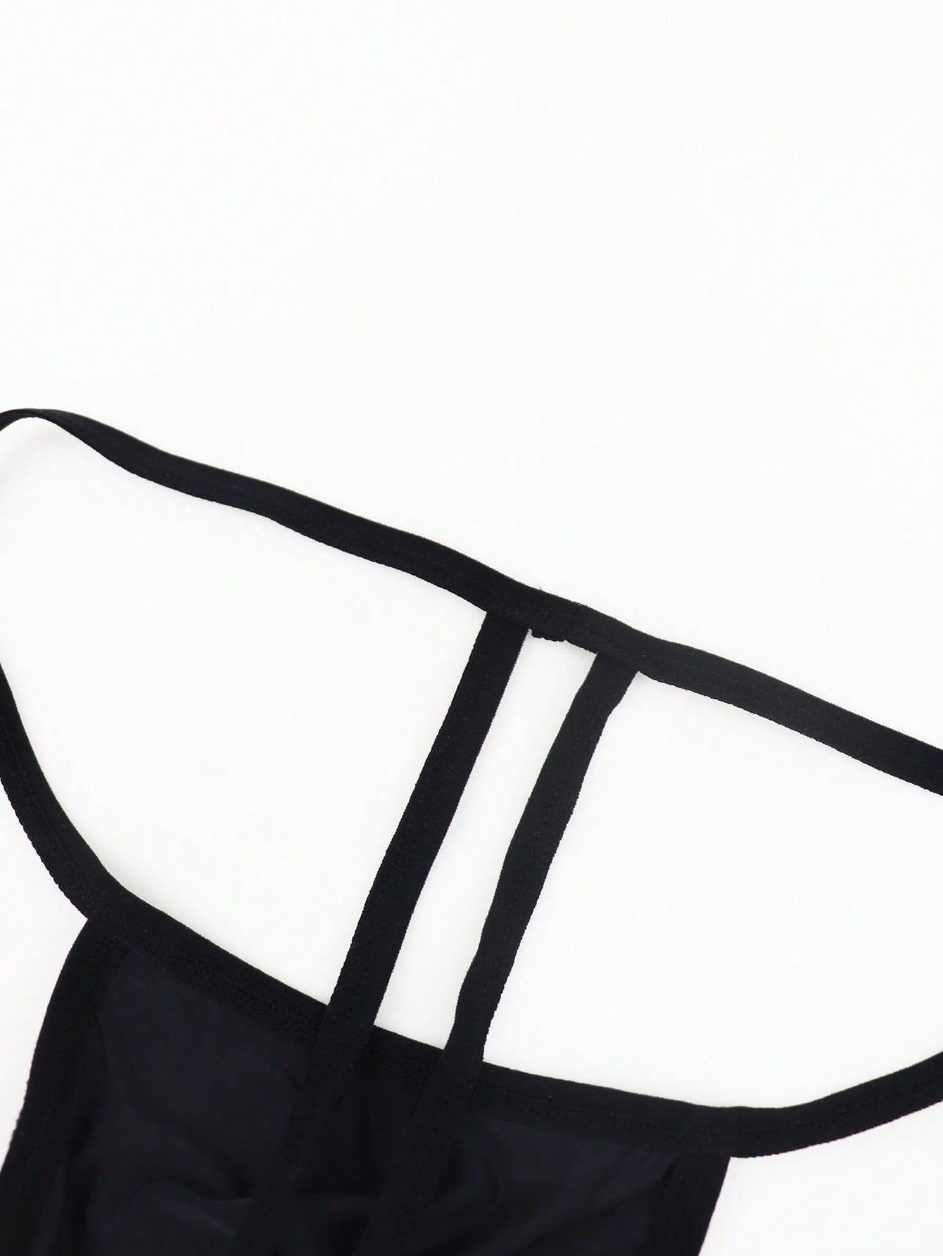 Black men's low-rise thong underwear made from breathable knitted fabric with medium stretch and a plain opaque design.