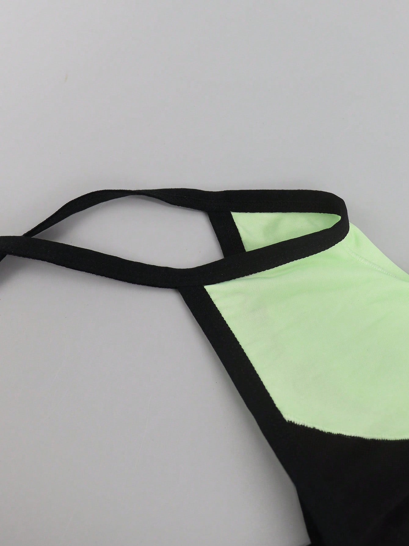 Men's multicolor mesh thong underwear with a plain design and mid-rise fit, made from stretchy polyester and elastane blend.