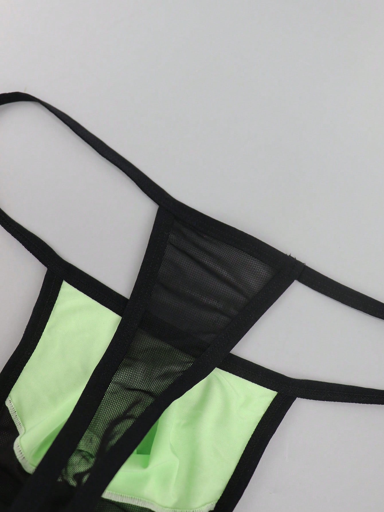 Men's multicolor mesh thong underwear with a plain design and mid-rise fit, made from stretchy polyester and elastane blend.