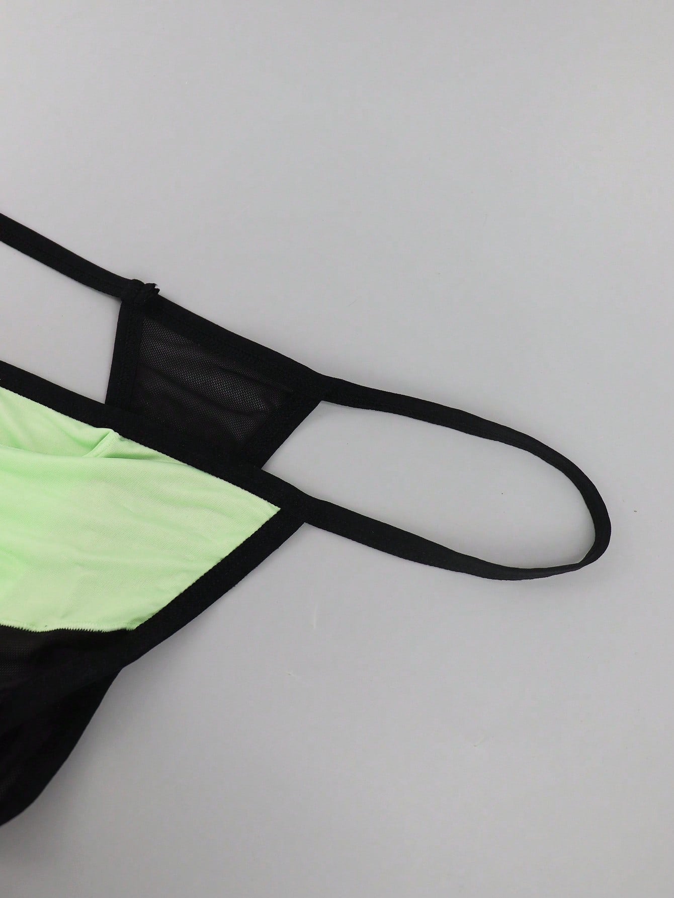 Men's multicolor mesh thong underwear with a plain design and mid-rise fit, made from stretchy polyester and elastane blend.