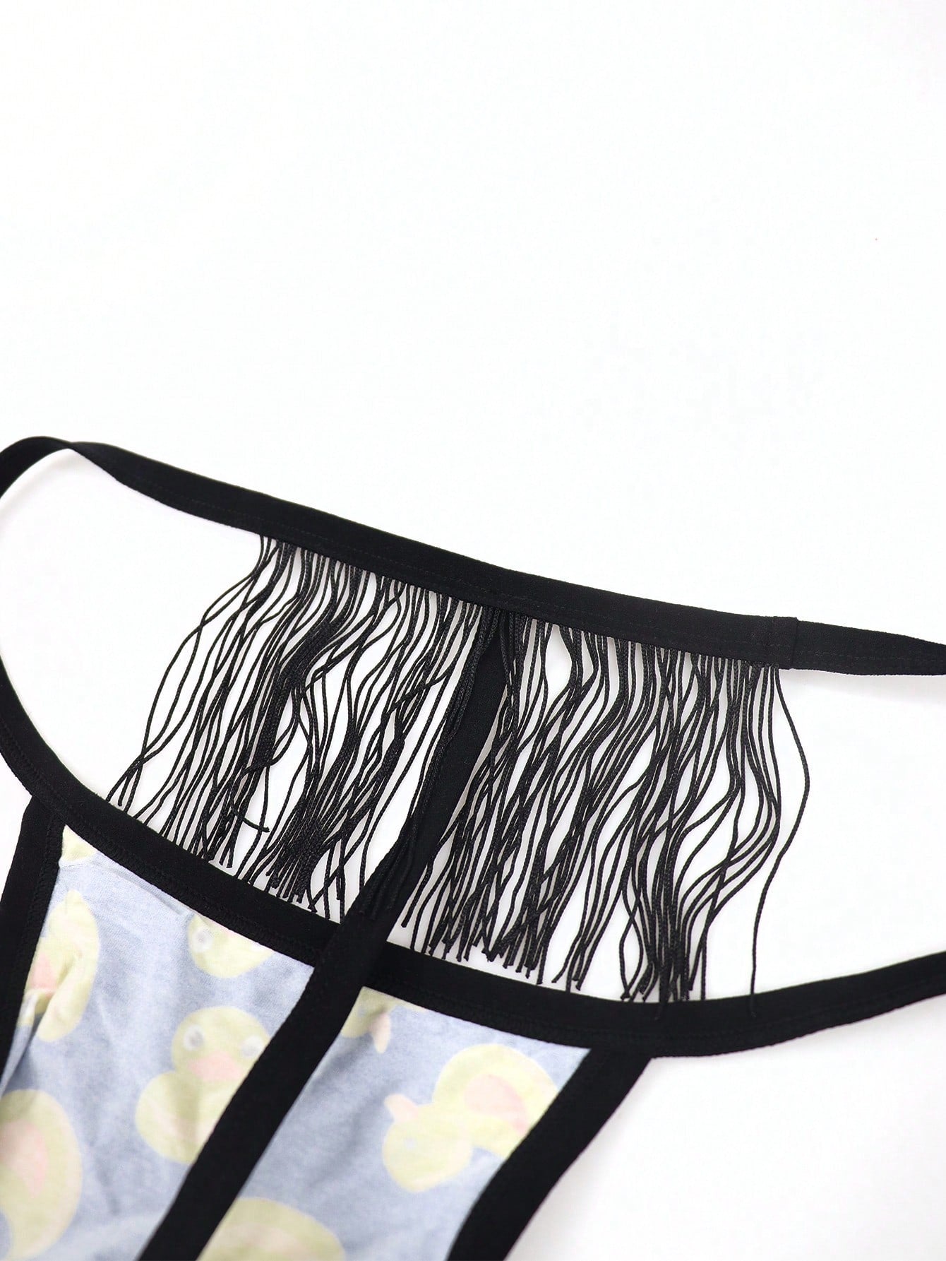 Men's seamless low-rise thong underwear in knitted viscose blend with medium stretch and geometric letter print.