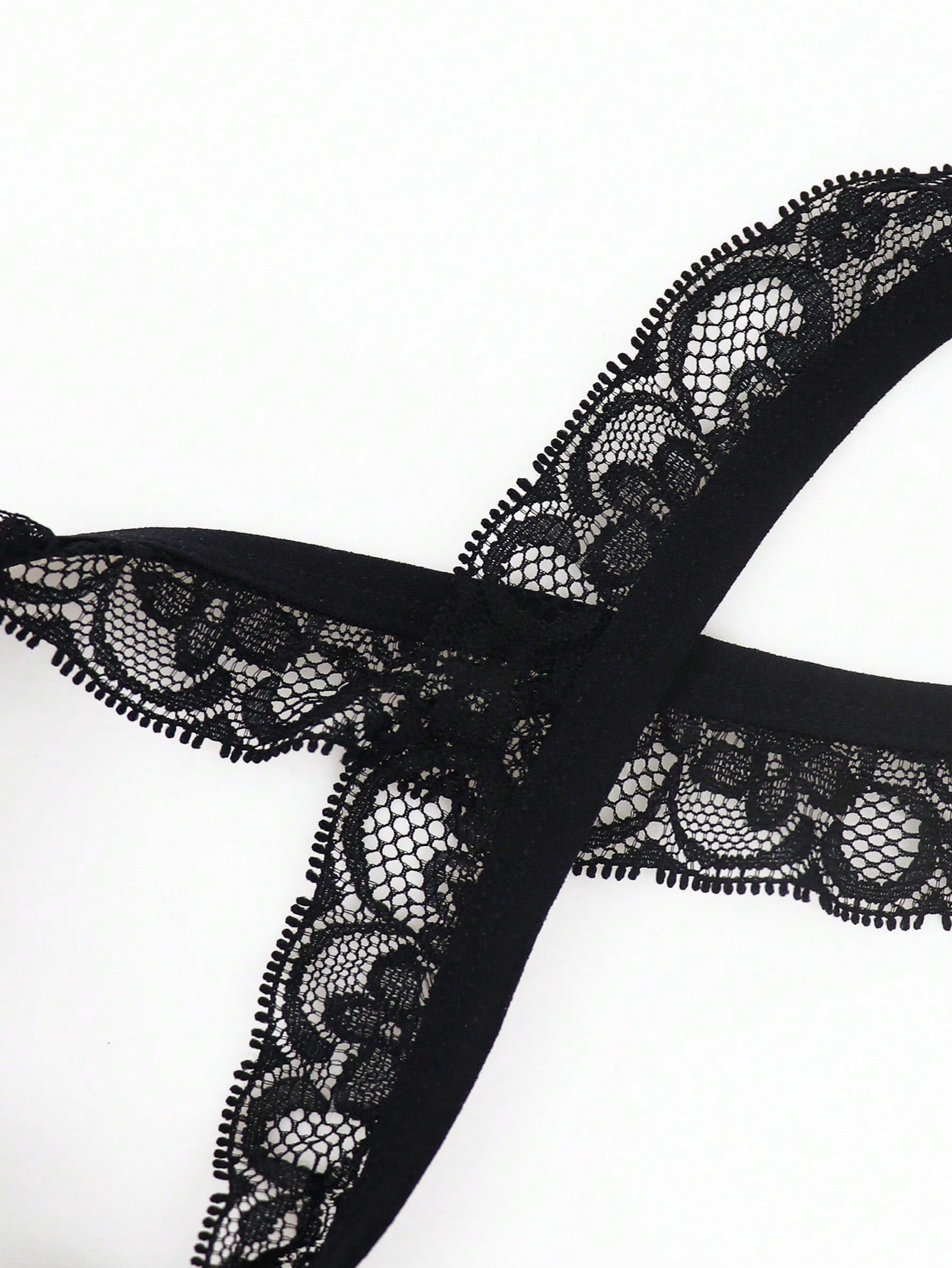 Black men's low rise thong underwear in knitted fabric with lace styling, letter pattern, medium stretch, and a non-sheer finish.