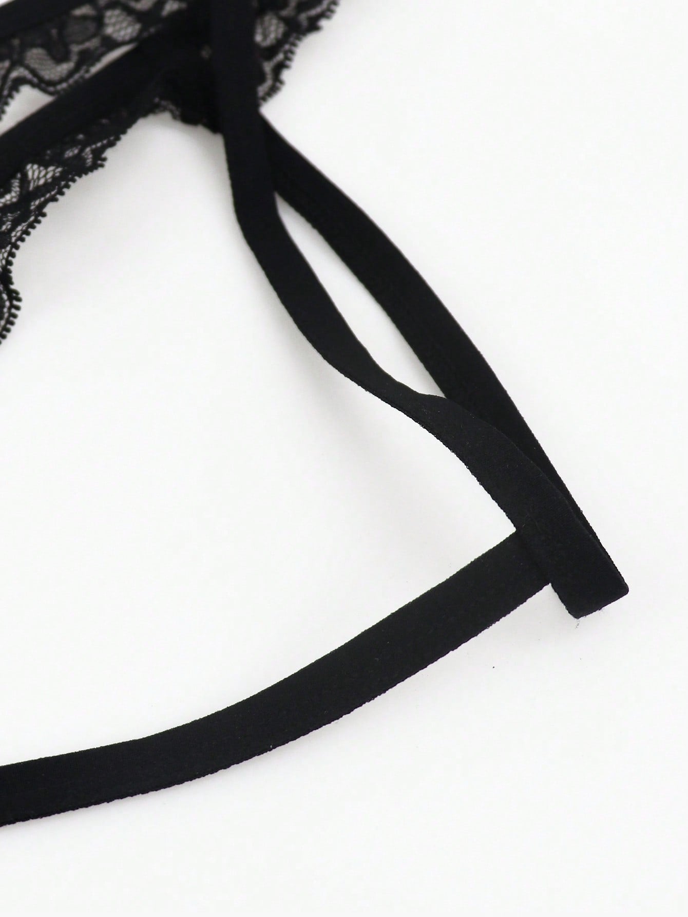 Black men's low rise thong underwear in knitted fabric with lace styling, letter pattern, medium stretch, and a non-sheer finish.