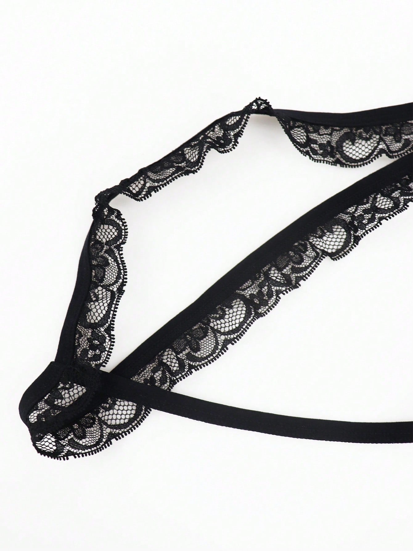 Black men's low rise thong underwear in knitted fabric with lace styling, letter pattern, medium stretch, and a non-sheer finish.