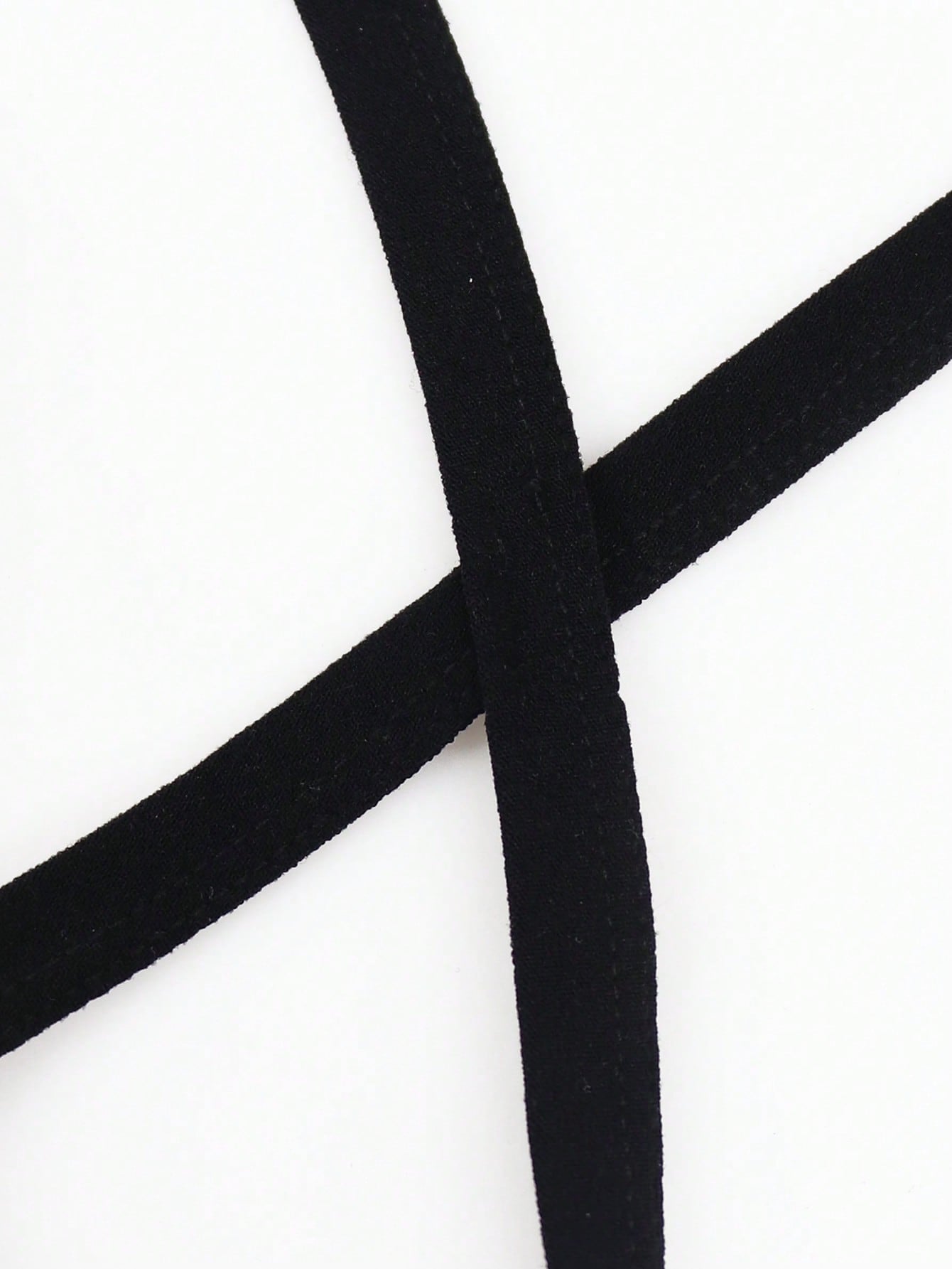 Black men's thong underwear with a low-rise waist, plain design, and knitted stretch fabric.