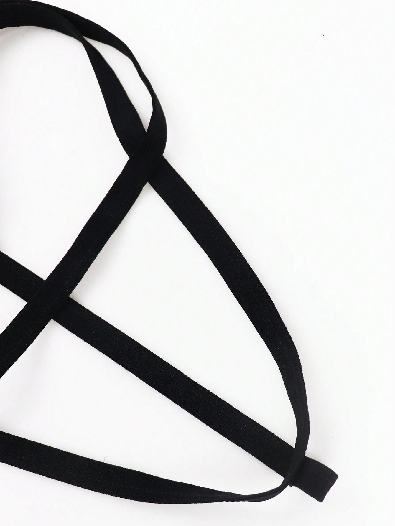 Black men's thong underwear with a low-rise waist, plain design, and knitted stretch fabric.