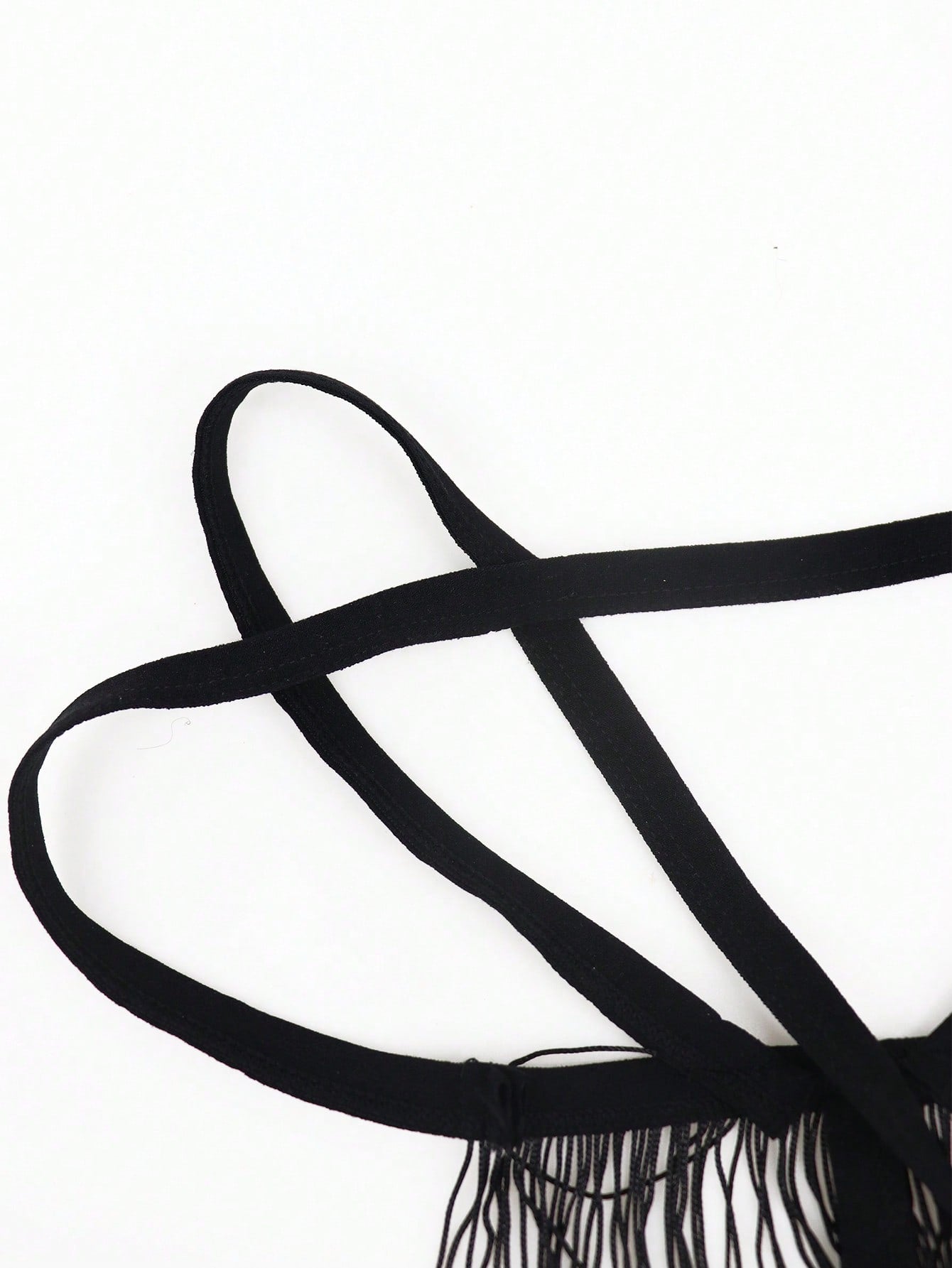 Black men's thong underwear with a low-rise waist, plain design, and knitted stretch fabric.